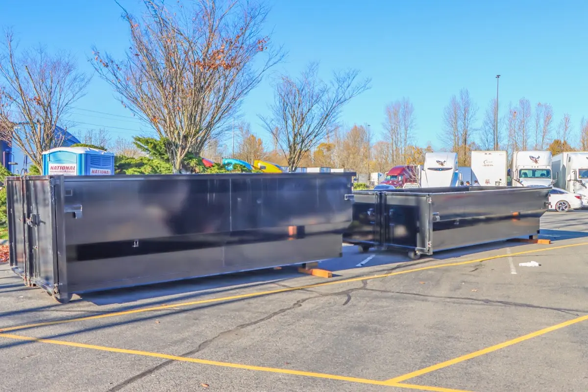 Professional dumpster rental service with roll-off container on residential driveway in Mead Valley